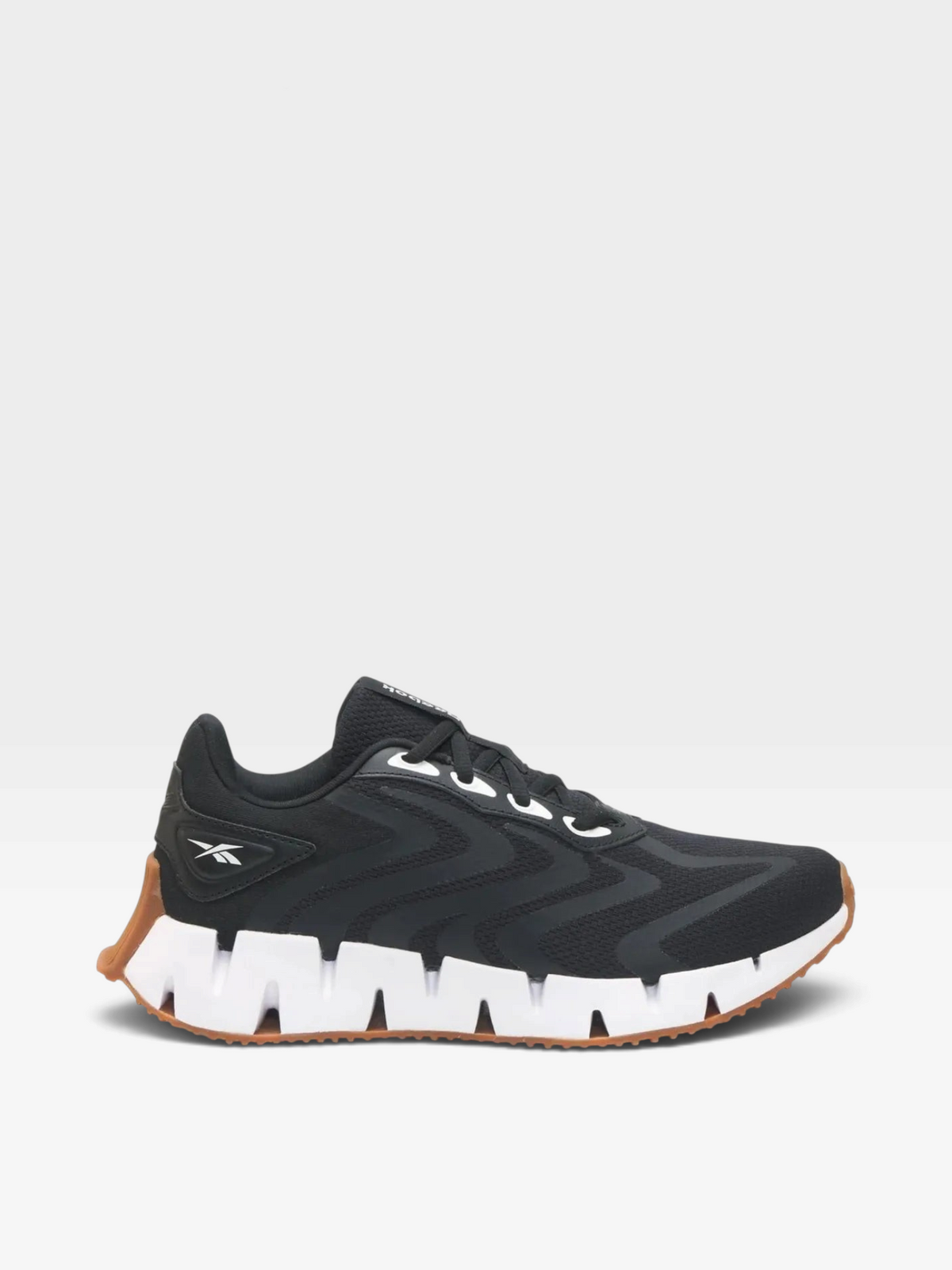 Zapatillas de running oklahoma Reebok negras con suela blanca dentada y detalles en color caramelo